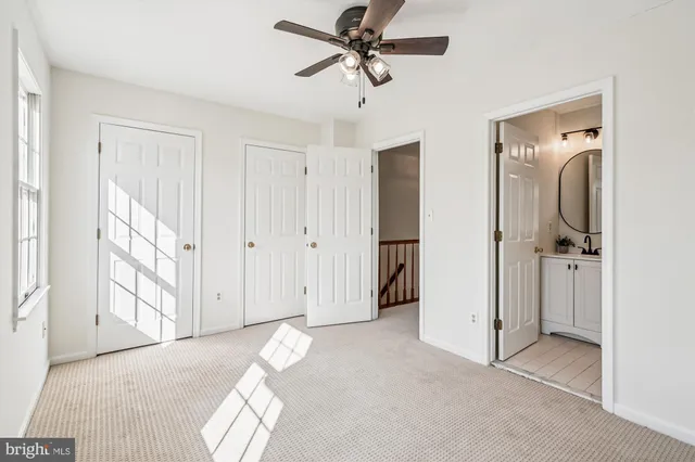a view of a livingroom with a chandelier fan and closet area