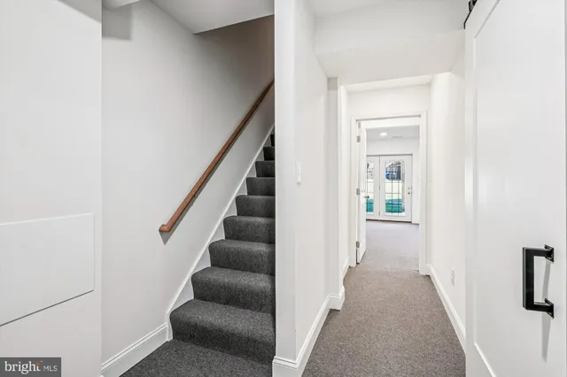a view of a hallway with wooden floor and entryway
