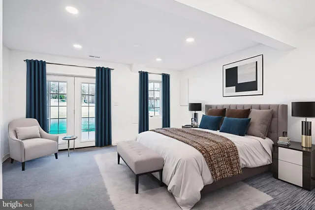 a spacious bedroom with a bed and a couch