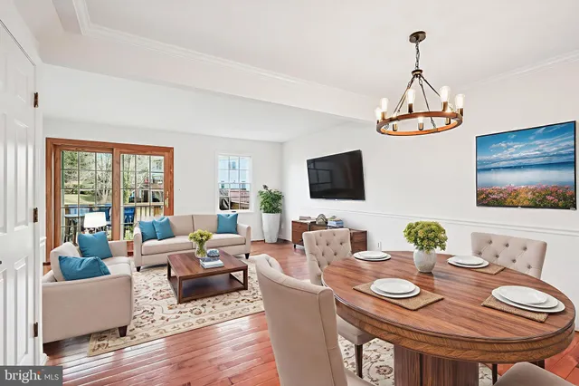 a living room with fireplace furniture and a wooden floor