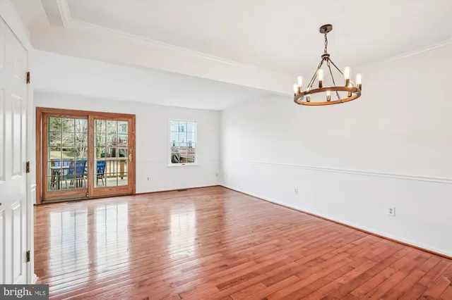 a view of a room with wooden floor and window