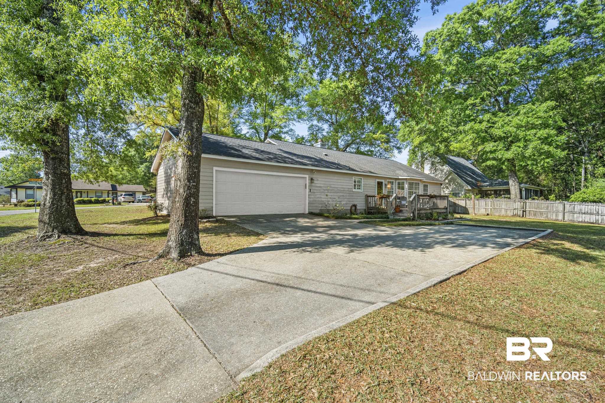 117 Richmond Road Daphne, AL 36526 - Photo 29 of 41 View of home's exterior with driveway, a deck, and an attached garage