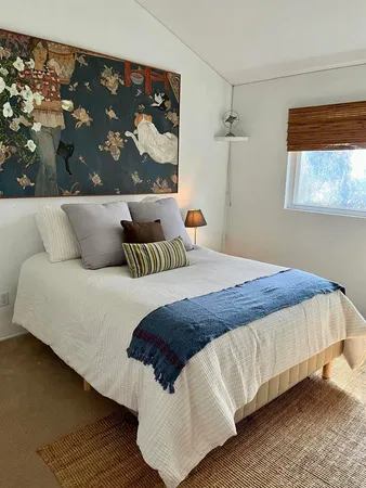 a bedroom with a bed and window