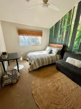 a bedroom with bed and window