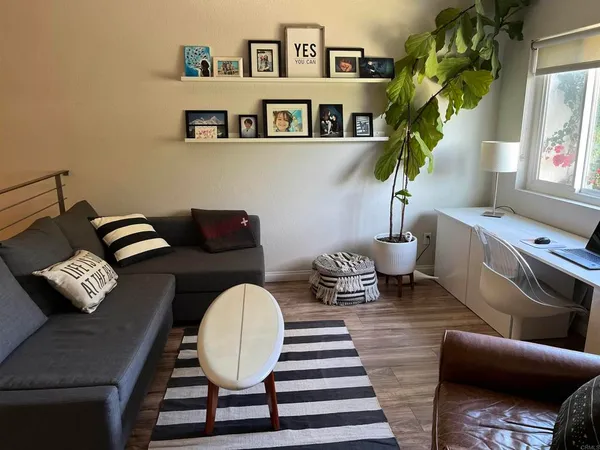 a living room with furniture and a mirror