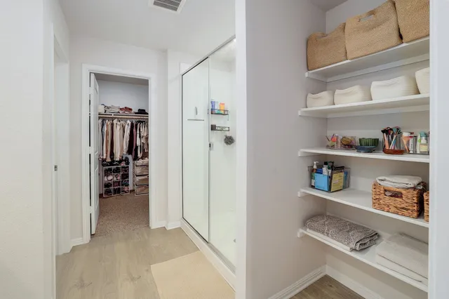 a en suite bathroom with a granite countertop sink and a mirror