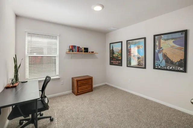 a view of workspace with projector and furniture
