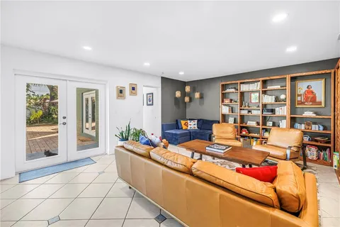 a view of a livingroom with wooden floor and a ceiling fan