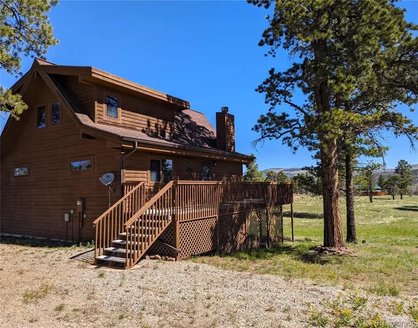 a view of a house with wooden fence