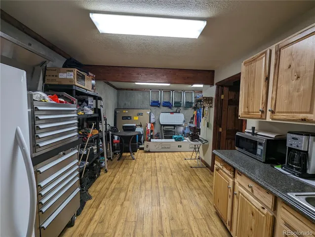 a kitchen with stainless steel appliances granite countertop a sink dishwasher and cabinets with wooden floor