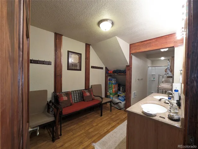 a living room with furniture and a mirror