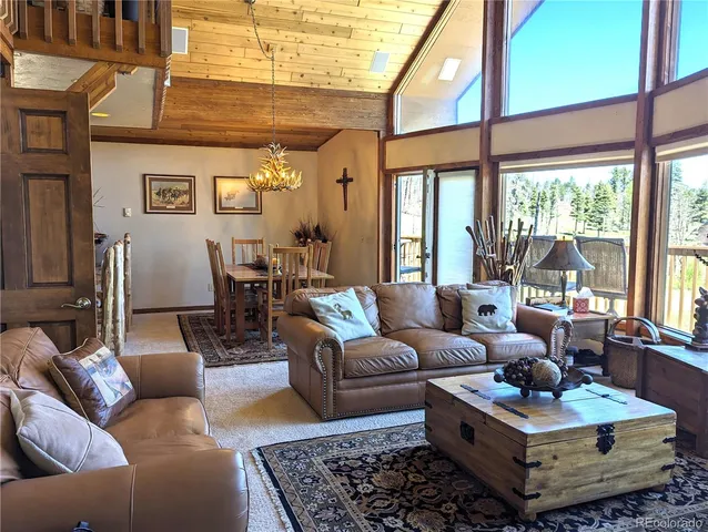 a living room with furniture a rug and a fireplace