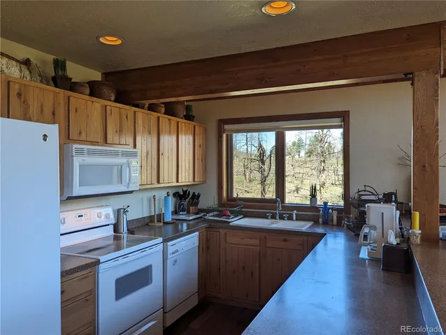 a view of living room and kitchen with furniture wooden floor and window