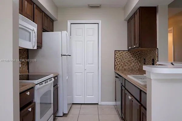 a kitchen with a refrigerator stove and microwave