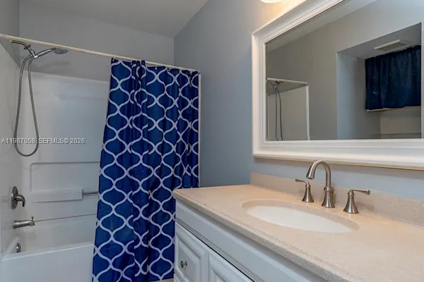 a view of a house with swimming pool and a yard with palm trees