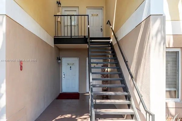 a view of entryway with wooden floor and stairs