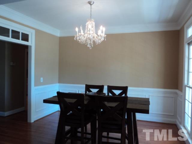 1108 Coram Fields Road Wake Forest, NC 27587 - Photo 2 of 24 a view of a dining room with furniture and chandelier