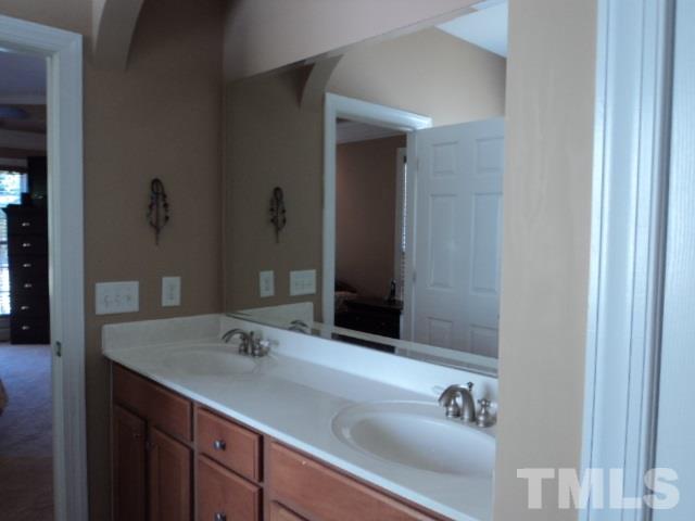 1108 Coram Fields Road Wake Forest, NC 27587 - Photo 11 of 24 a bathroom with a sink and a mirror
