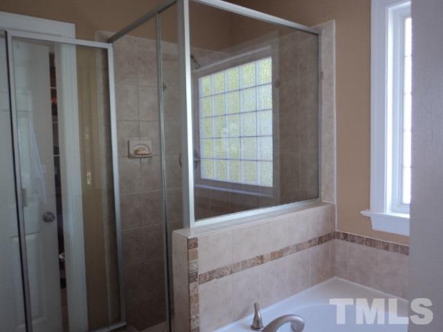 1108 Coram Fields Road Wake Forest, NC 27587 - Photo 12 of 24 a bathroom with a bathtub and shower