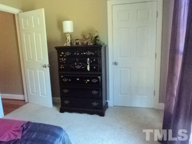 1108 Coram Fields Road Wake Forest, NC 27587 - Photo 14 of 24 a living room with a dresser and a mirror
