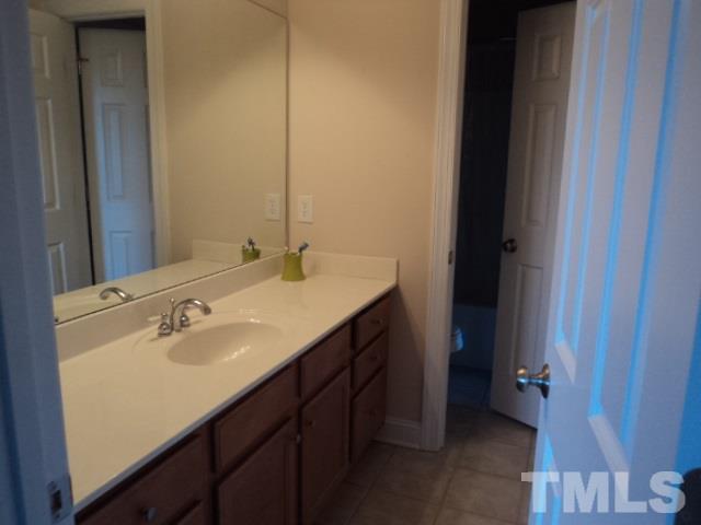 1108 Coram Fields Road Wake Forest, NC 27587 - Photo 18 of 24 a bathroom with a sink and a mirror