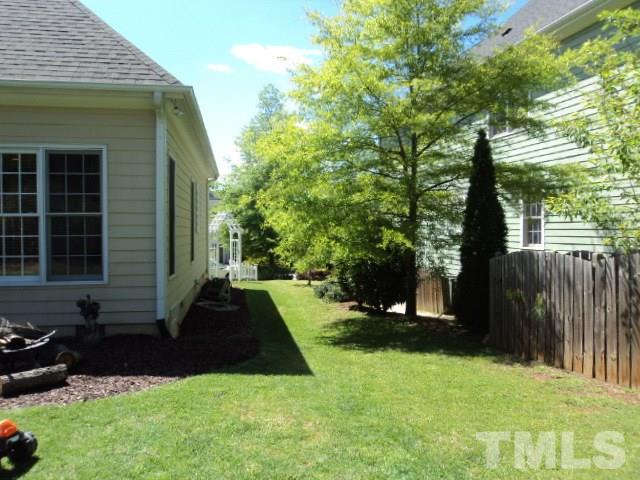 1108 Coram Fields Road Wake Forest, NC 27587 - Photo 22 of 24 a front view of a house with a yard