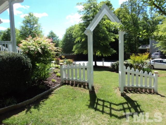 1108 Coram Fields Road Wake Forest, NC 27587 - Photo 24 of 24 a view of a chair and table in backyard of the house