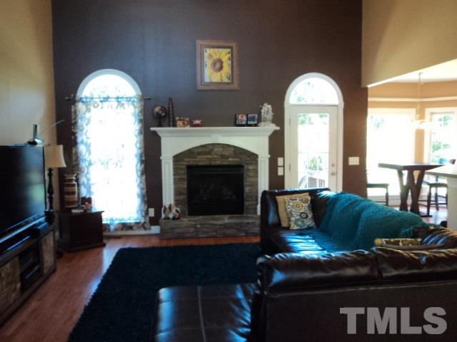 1108 Coram Fields Road Wake Forest, NC 27587 - Photo 5 of 24 a living room with furniture and a fireplace