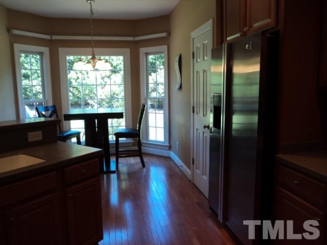 1108 Coram Fields Road Wake Forest, NC 27587 - Photo 8 of 24 a view of a hallway with furniture and wooden floor