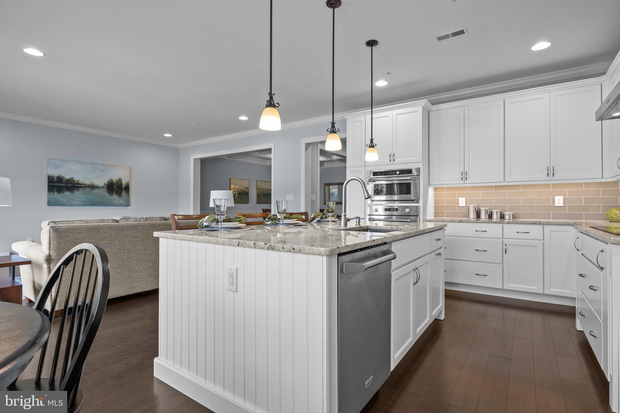 23 David Drive Newtown, PA 18940 - Photo 12 of 44 a kitchen with kitchen island granite countertop a stove a sink a center island with wooden floor and cabinets