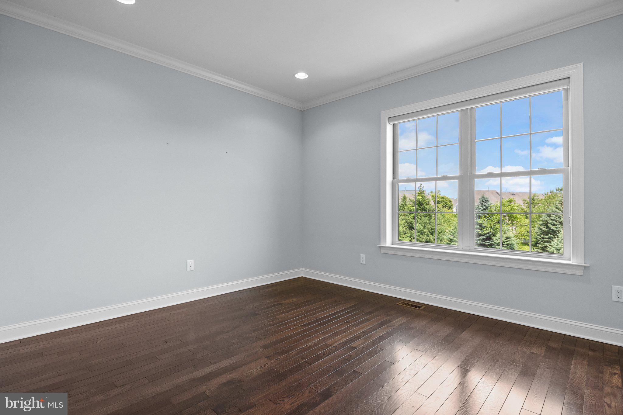 23 David Drive Newtown, PA 18940 - Photo 33 of 44 an empty room with wooden floor and windows
