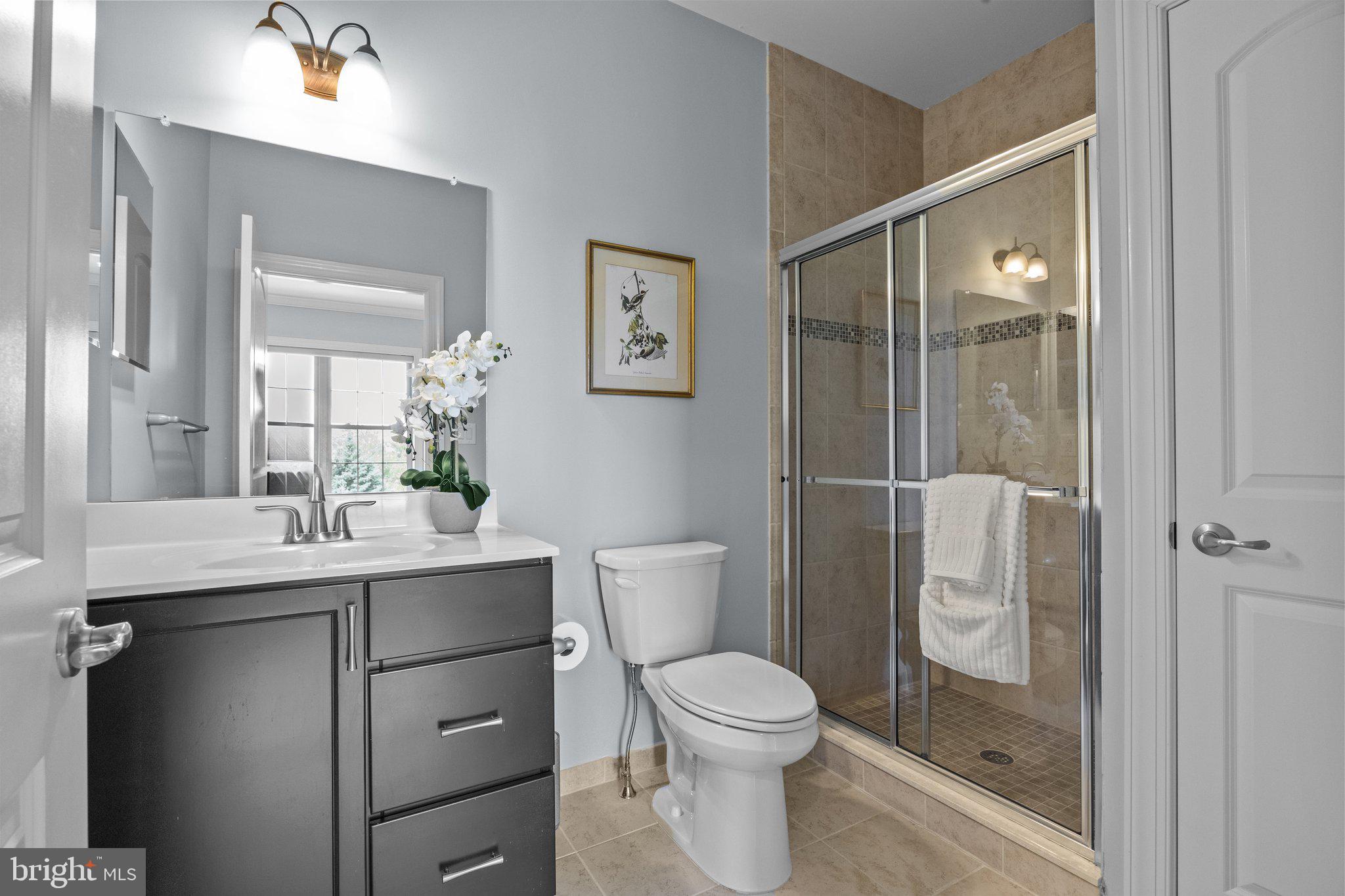 23 David Drive Newtown, PA 18940 - Photo 34 of 44 a bathroom with a toilet a sink and glass door