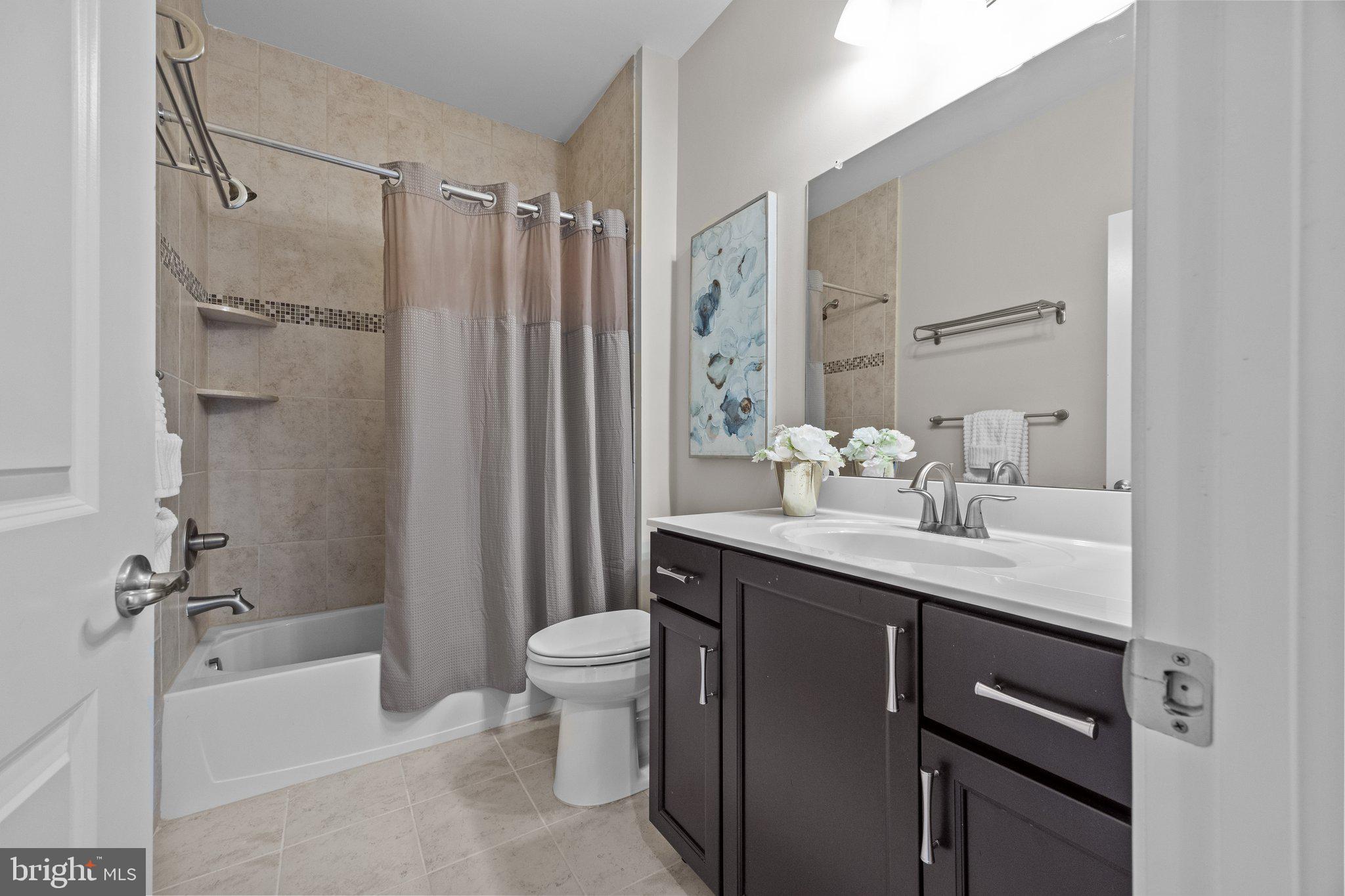 23 David Drive Newtown, PA 18940 - Photo 36 of 44 a bathroom with a granite countertop sink a toilet and shower