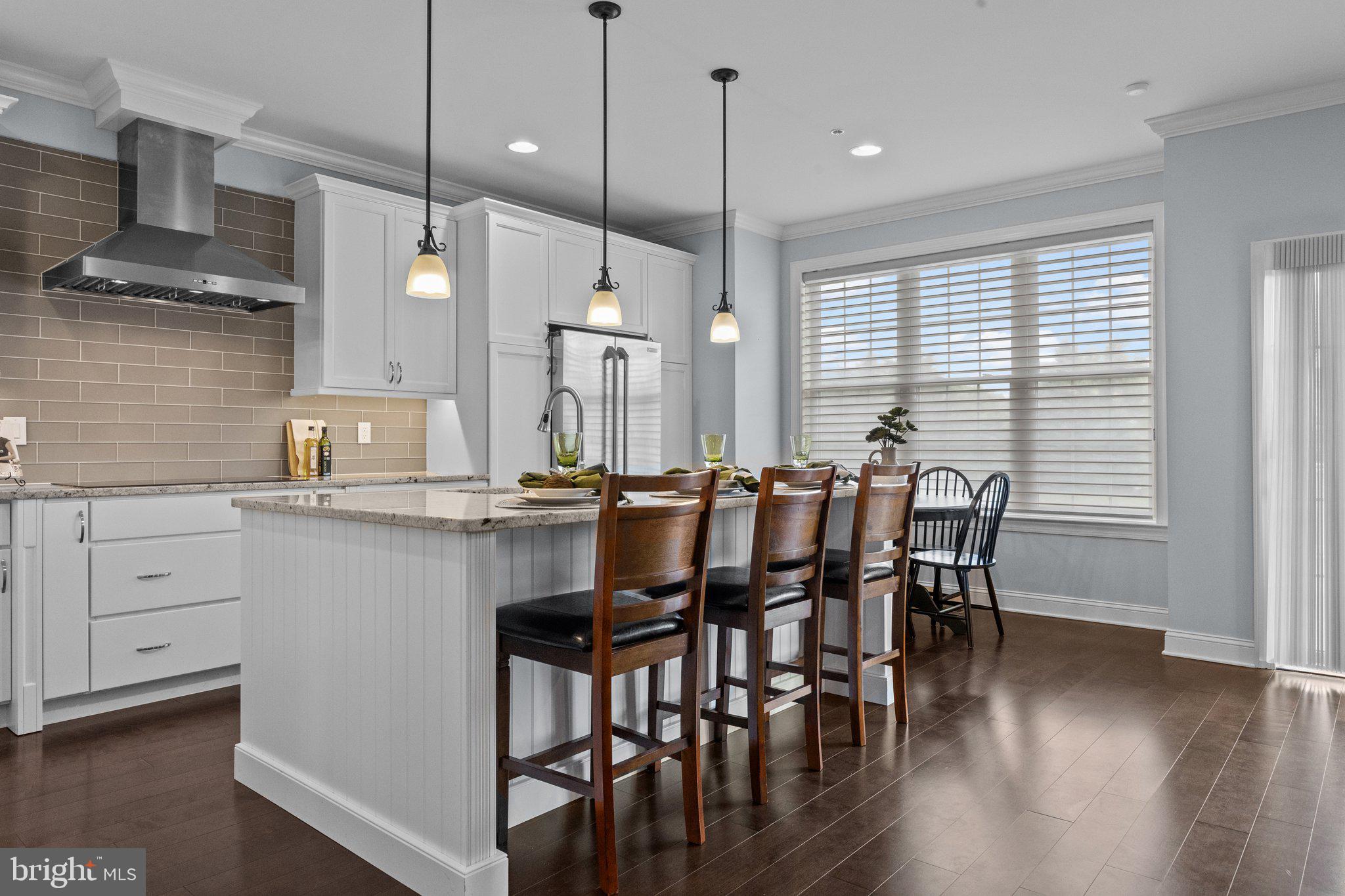 23 David Drive Newtown, PA 18940 - Photo 8 of 44 a kitchen with a table chairs wooden floors and a view of living room