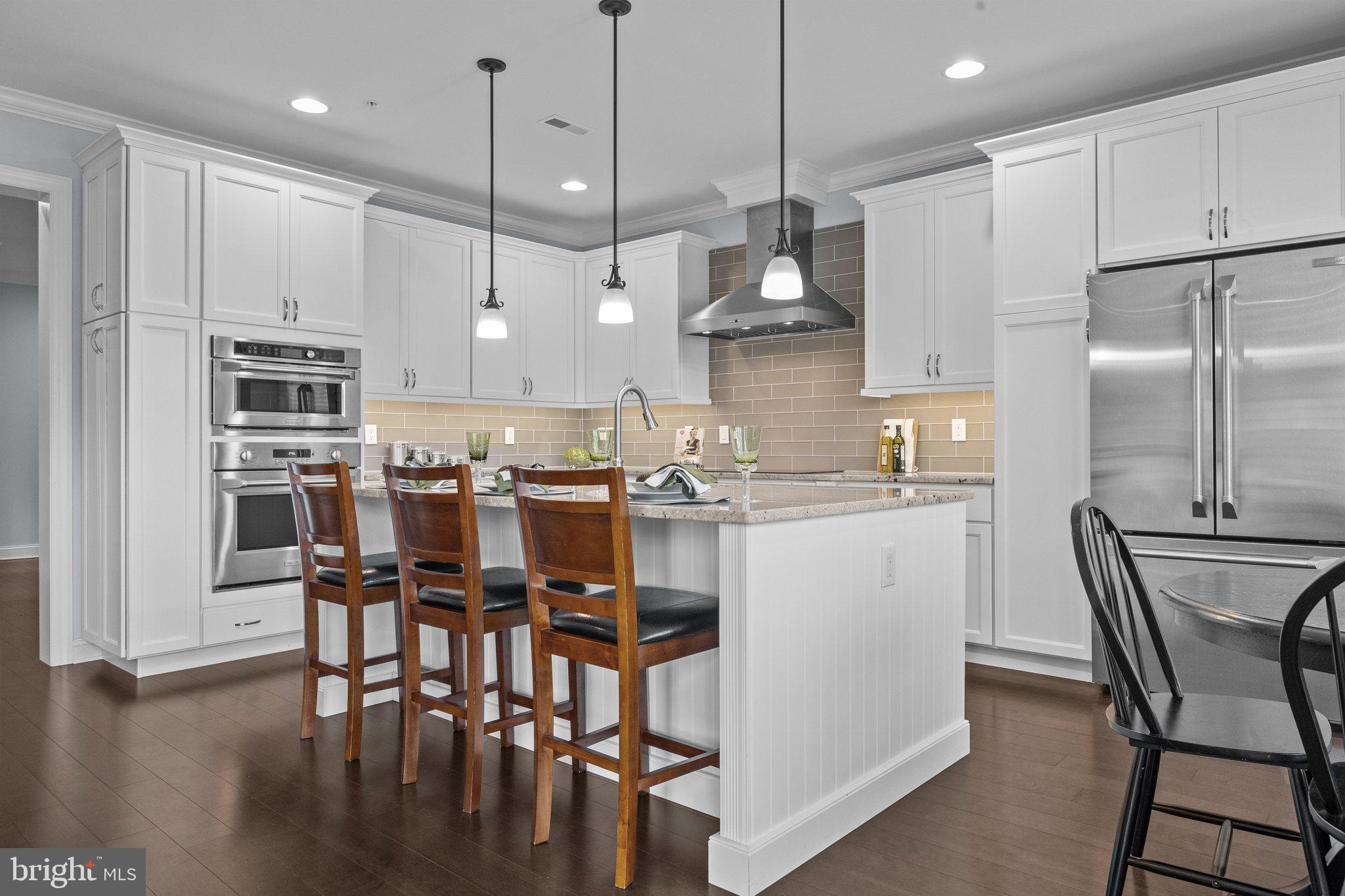 23 David Drive Newtown, PA 18940 - Photo 9 of 44 a kitchen with kitchen island white cabinets and stainless steel appliances