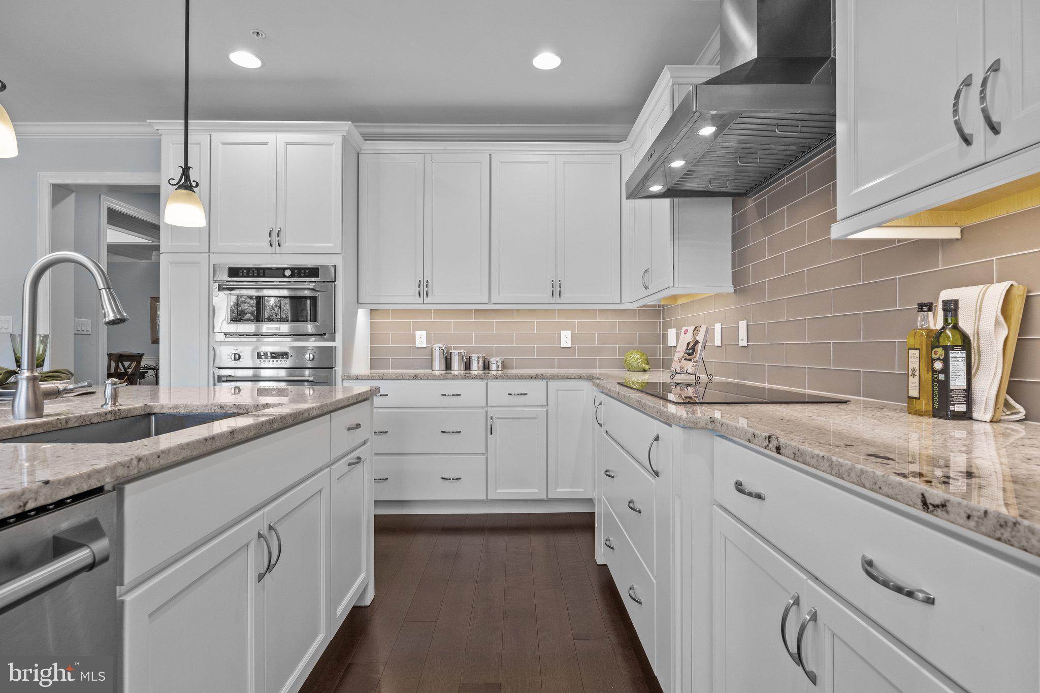 23 David Drive Newtown, PA 18940 - Photo 10 of 44 a kitchen with granite countertop white cabinets and white appliances