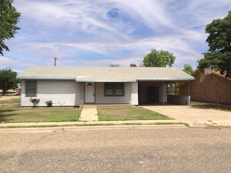 1003 16th Street Ralls, TX 79357 - Photo 1 of 9 a view of a house with a yard and garage