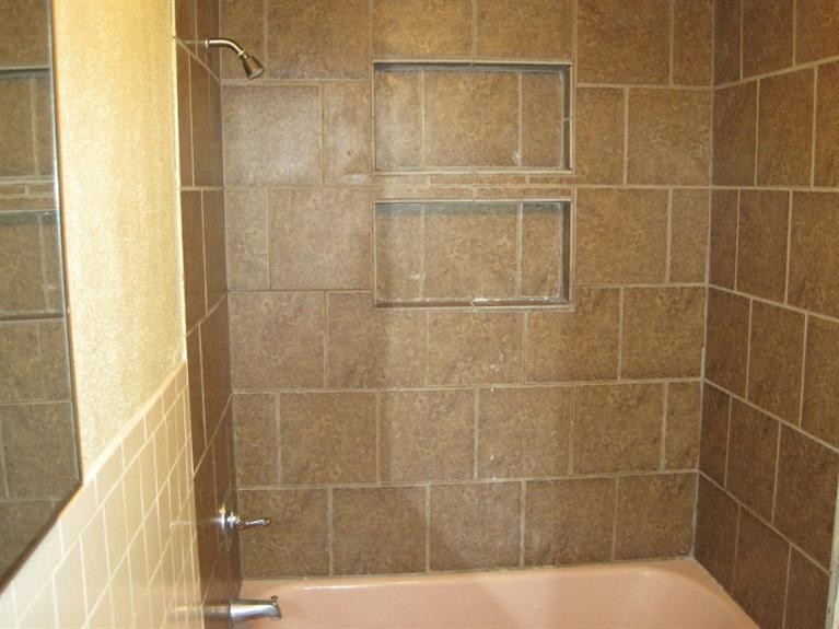1003 16th Street Ralls, TX 79357 - Photo 7 of 9 a bathroom with a shower