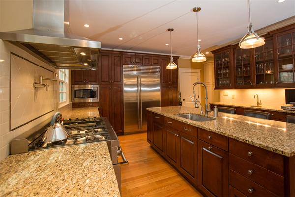 37 Beechwood Road Wellesley, MA 02482 - Photo 12 of 24 a large kitchen with stainless steel appliances a large counter top a stove a sink and a refrigerator