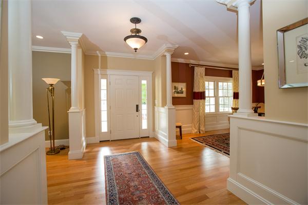 37 Beechwood Road Wellesley, MA 02482 - Photo 5 of 24 a view of a hallway with wooden floor and a living room