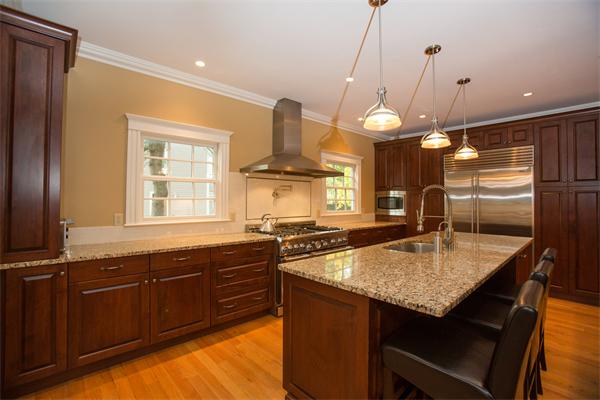 37 Beechwood Road Wellesley, MA 02482 - Photo 10 of 24 a kitchen with granite countertop cabinets stainless steel appliances a sink and a chandelier
