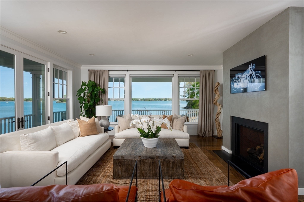 151 Downer Avenue Hingham, MA 02043 - Photo 6 of 19 a living room with furniture large window and a fireplace