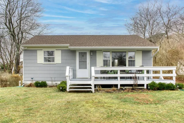 a backyard of a house with large trees and barbeque oven