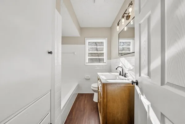a room with a sink a bed and a window