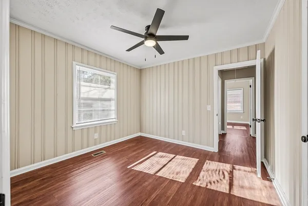 wooden floor in an empty room with a window