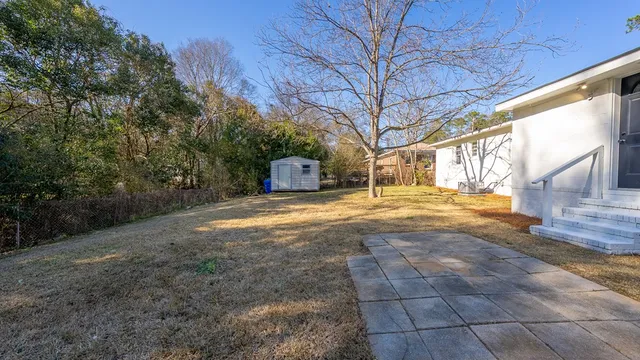 a view of backyard with wooden fence