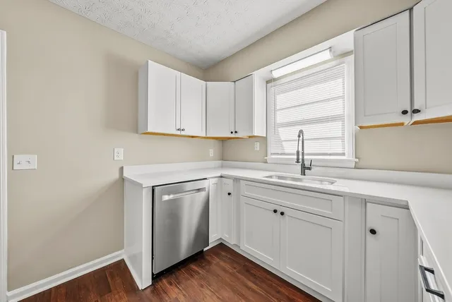 a kitchen with a sink cabinets and window