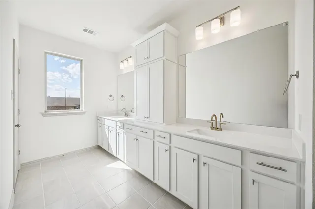 a kitchen with a sink and wooden floor