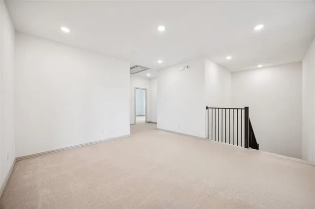 a kitchen with granite countertop white cabinets and stainless steel appliances