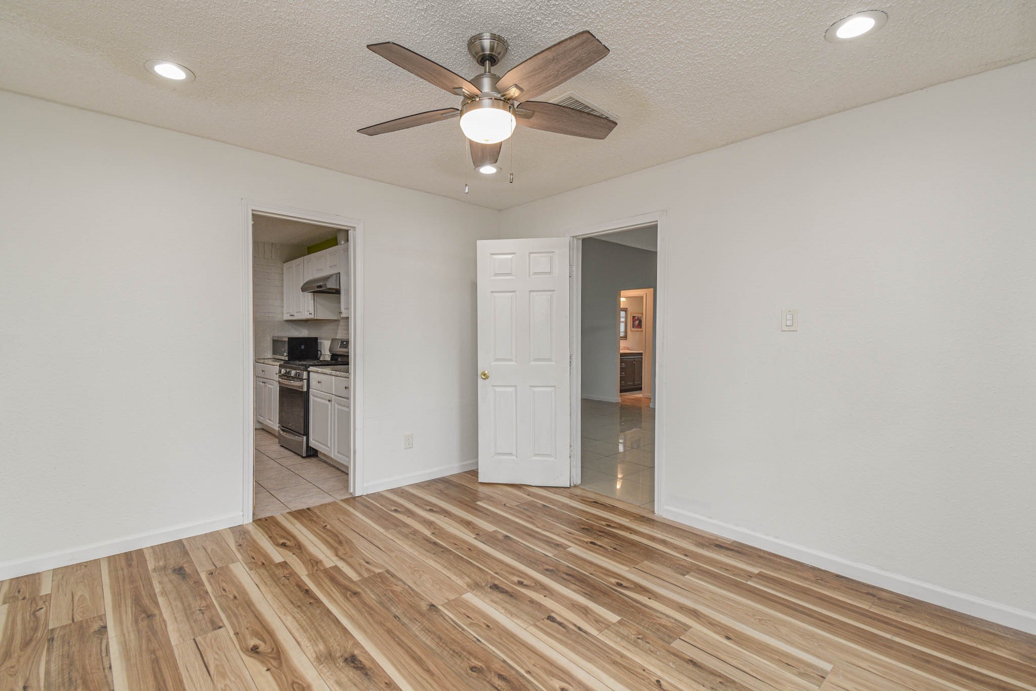 12054 Plumpoint Drive Houston, TX 77099 - Photo 13 of 24 a view of a room with closet and ceiling fan